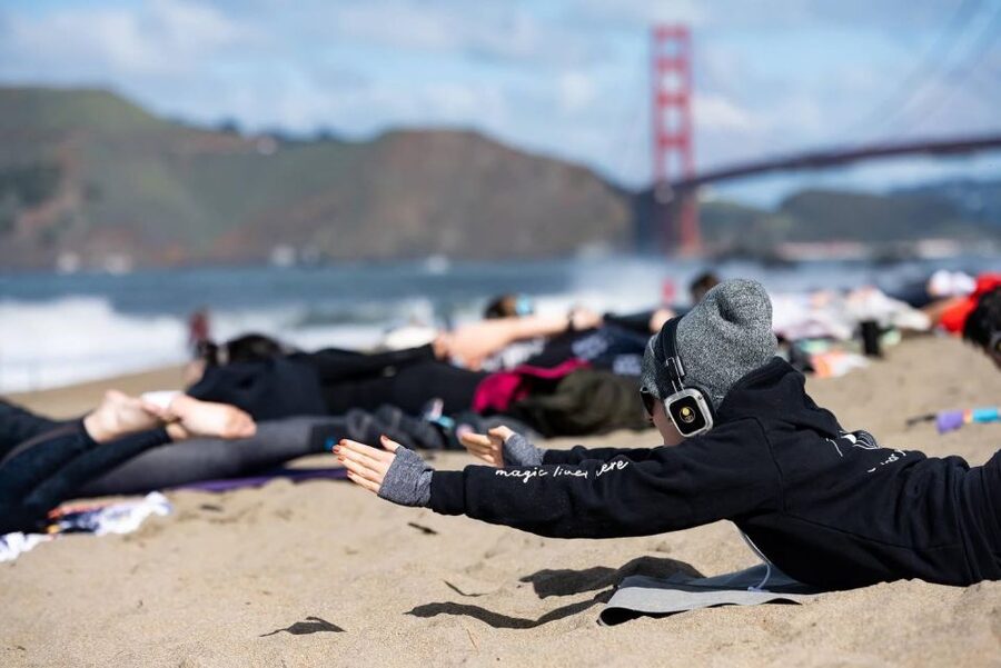 San Francisco: Silent Disco Yoga at Baker Beach - The yoga approach: all levels welcome, with room to challenge yourself